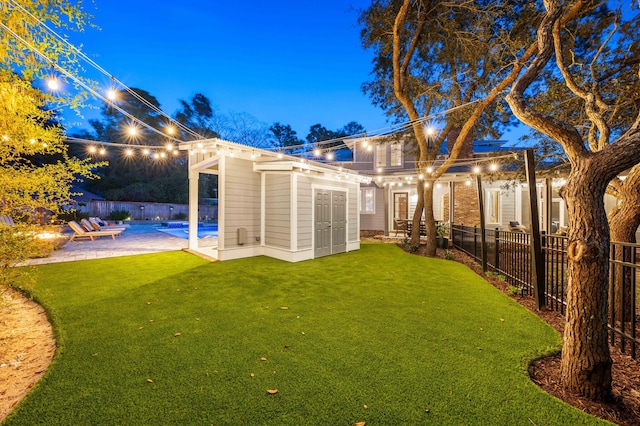 rear view of house featuring a patio area and a yard