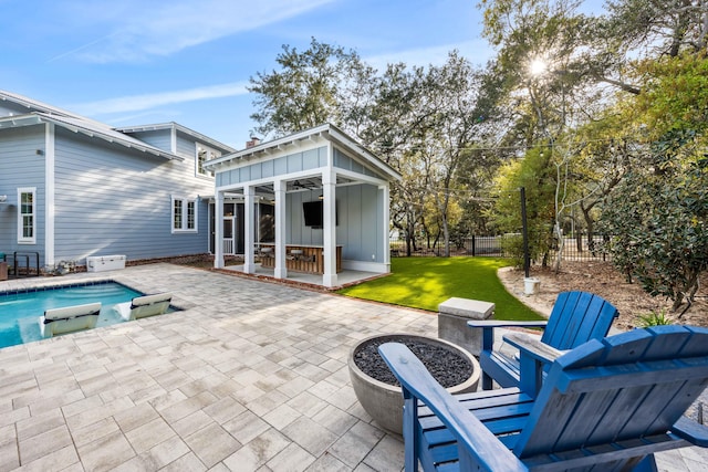 view of patio featuring ceiling fan and an outdoor structure