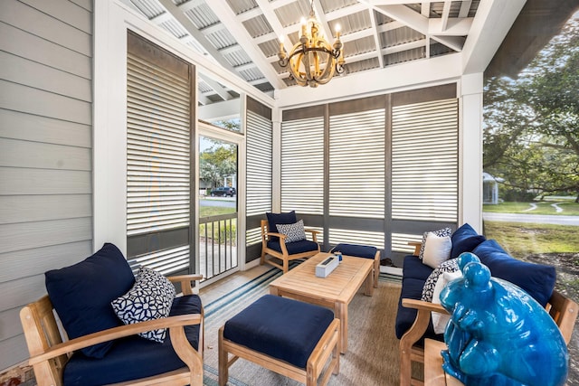 sunroom / solarium with a chandelier and lofted ceiling