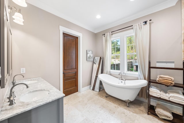 bathroom featuring vanity, a bathing tub, and crown molding