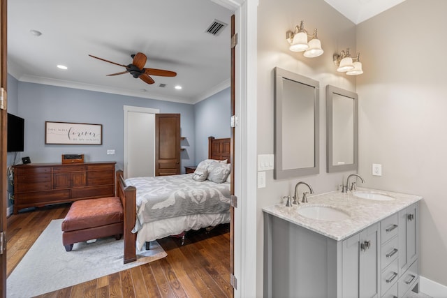 bedroom featuring ceiling fan, sink, and dark hardwood / wood-style floors