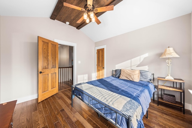 bedroom featuring ceiling fan, dark hardwood / wood-style flooring, and lofted ceiling with beams