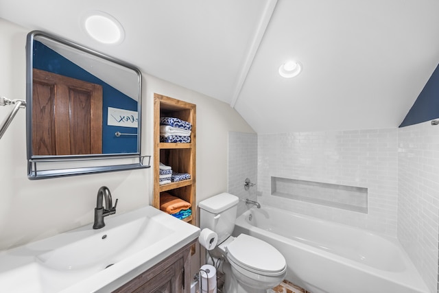 bathroom with a bathtub, vanity, vaulted ceiling, and toilet