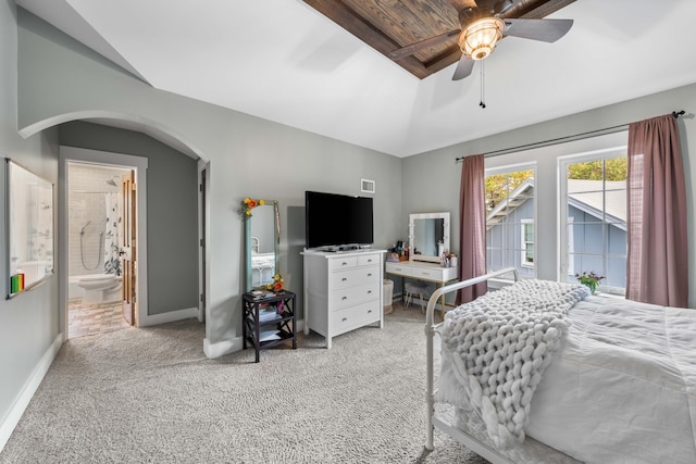 carpeted bedroom with ceiling fan, connected bathroom, and lofted ceiling