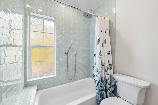 bathroom featuring toilet and shower / bath combo