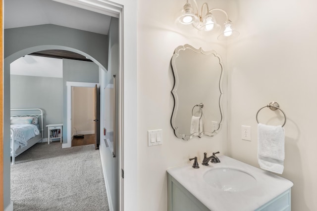 bathroom with vanity and vaulted ceiling