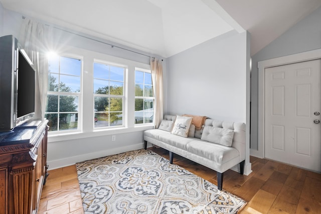 living area with vaulted ceiling and light hardwood / wood-style floors