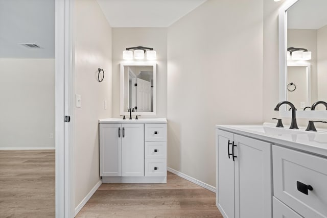 bathroom with hardwood / wood-style flooring and vanity