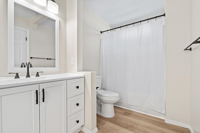 bathroom featuring hardwood / wood-style flooring, vanity, and toilet