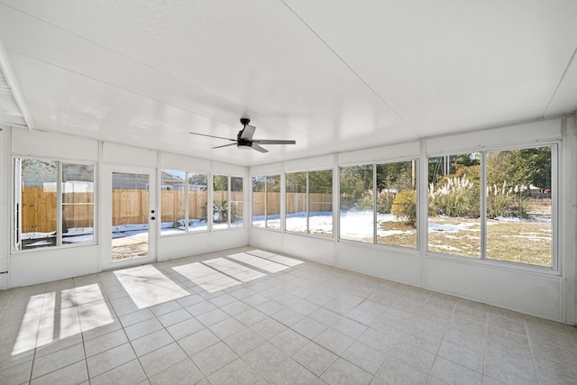 unfurnished sunroom with ceiling fan