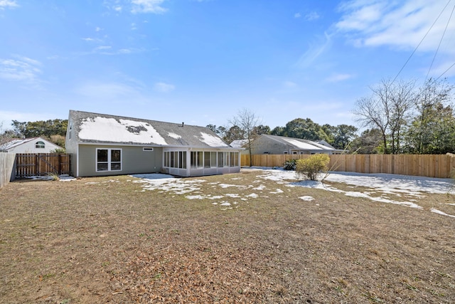 rear view of house featuring a sunroom