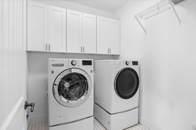 laundry area with cabinets and separate washer and dryer