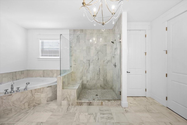 bathroom with an inviting chandelier and independent shower and bath