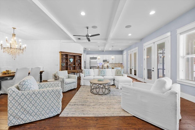 living room featuring dark wood-type flooring, beam ceiling, and ceiling fan with notable chandelier