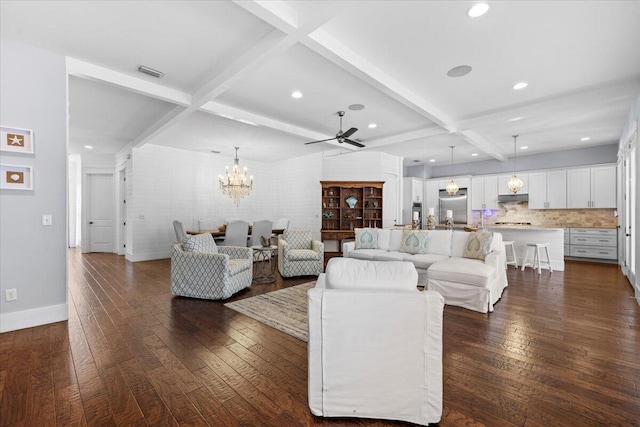 living room with dark hardwood / wood-style flooring, beam ceiling, ceiling fan with notable chandelier, and coffered ceiling