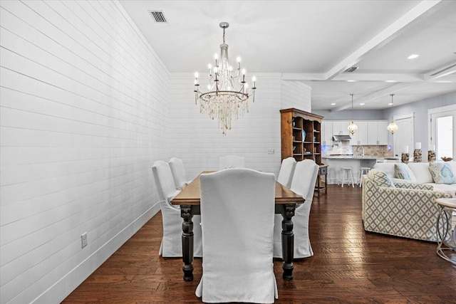 dining space with beam ceiling, dark hardwood / wood-style floors, and an inviting chandelier