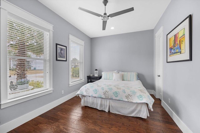 bedroom with dark hardwood / wood-style floors and ceiling fan