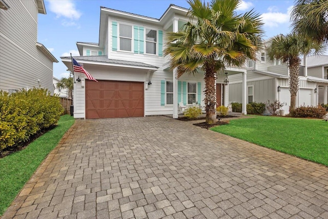 view of front of home with a garage and a front lawn