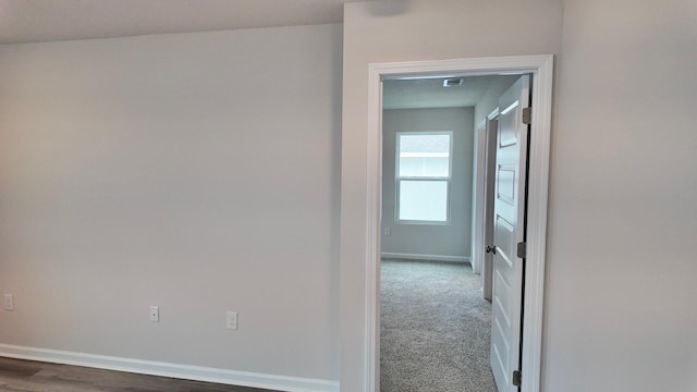 hallway with dark carpet