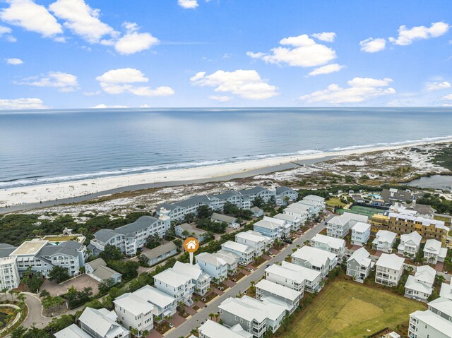 bird's eye view featuring a water view and a beach view