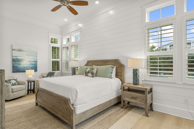 bedroom featuring ceiling fan, light wood-type flooring, and ornamental molding