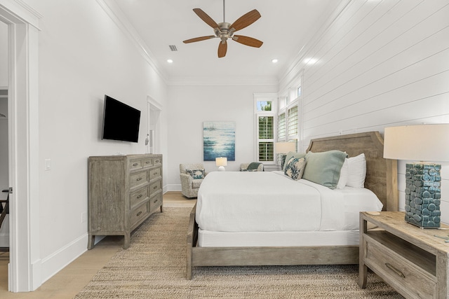 bedroom with ceiling fan, light hardwood / wood-style floors, and ornamental molding