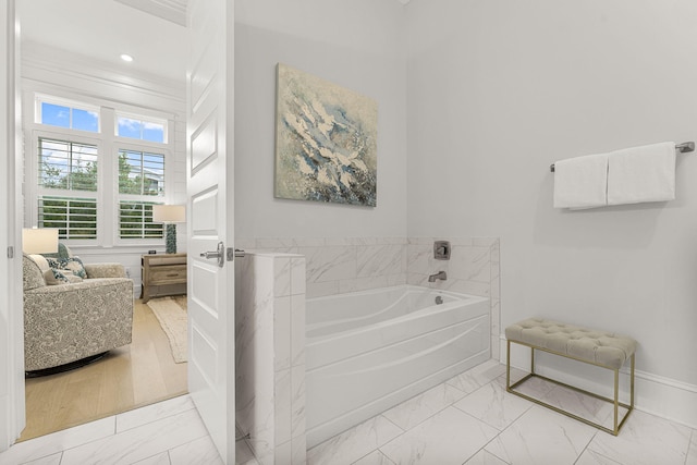 bathroom featuring a bath and ornamental molding