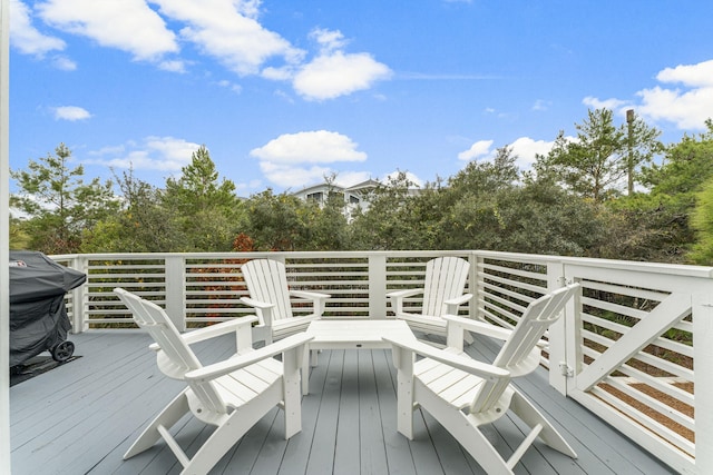 wooden terrace with a grill