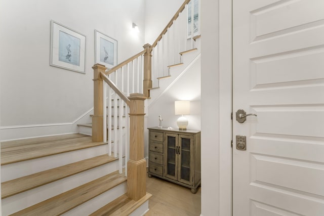 stairway featuring wood-type flooring