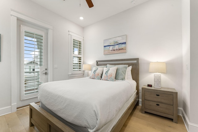 bedroom with light wood-type flooring, ceiling fan, and multiple windows