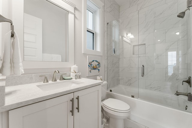 full bathroom featuring toilet, enclosed tub / shower combo, and vanity