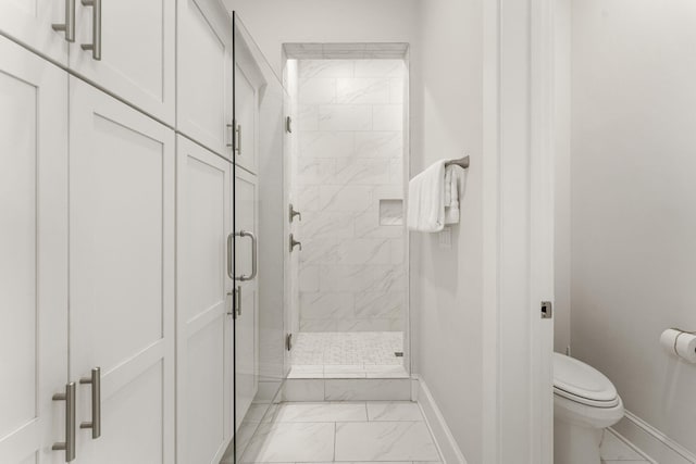 bathroom with toilet and an enclosed shower