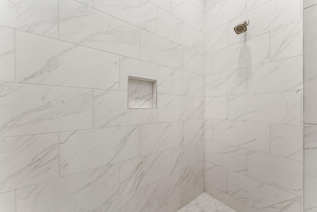 bathroom with a tile shower