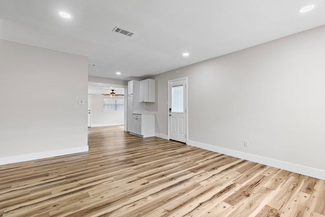 unfurnished living room with light hardwood / wood-style flooring and ceiling fan