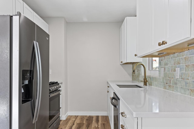 kitchen with white cabinetry, sink, decorative backsplash, and appliances with stainless steel finishes