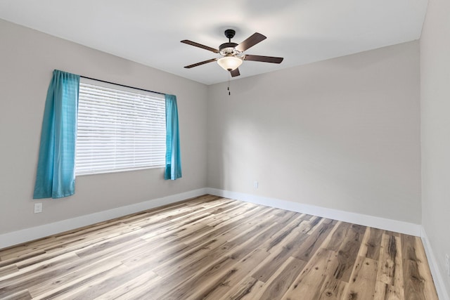 unfurnished room featuring ceiling fan and light wood-type flooring