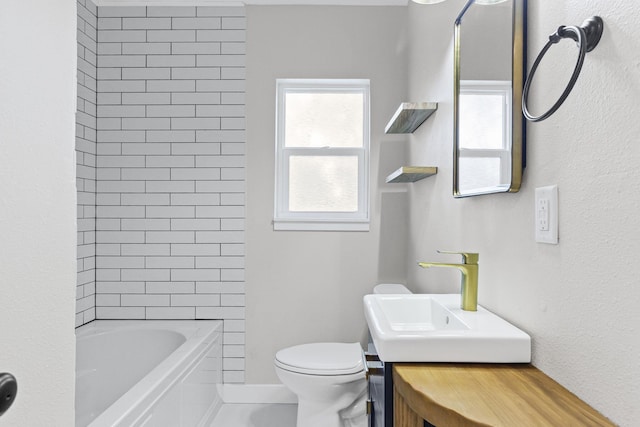 full bathroom with vanity, tiled shower / bath combo, and toilet