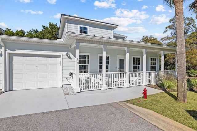 view of front of home featuring a porch and a garage