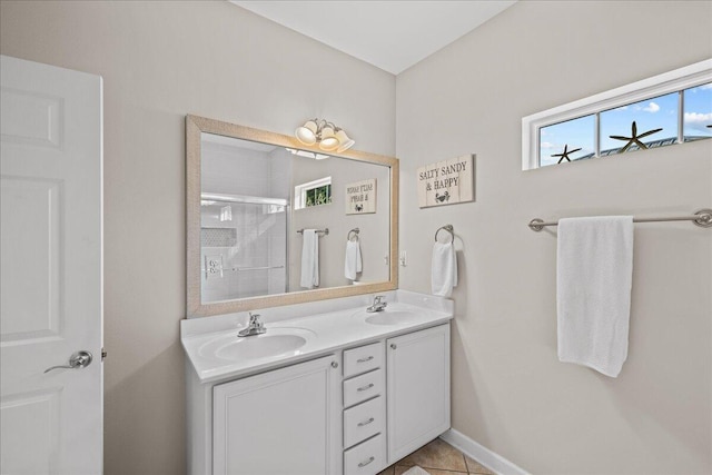 bathroom featuring a shower with door, tile patterned floors, and vanity