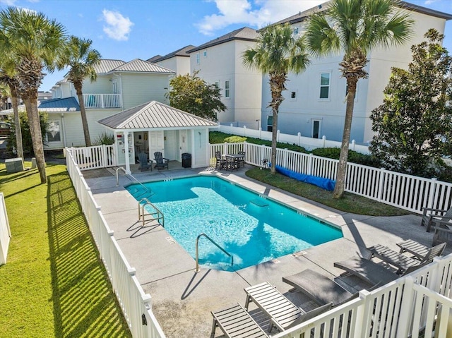 view of pool with a lawn and a patio area