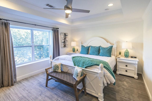 bedroom with ceiling fan, multiple windows, a tray ceiling, and crown molding