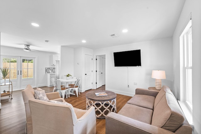 living room with ceiling fan, french doors, and hardwood / wood-style flooring