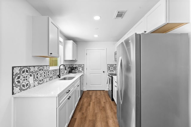 kitchen featuring sink, white cabinets, and stainless steel appliances