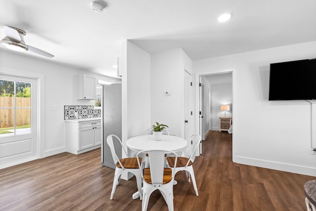 dining area with ceiling fan and dark wood-type flooring