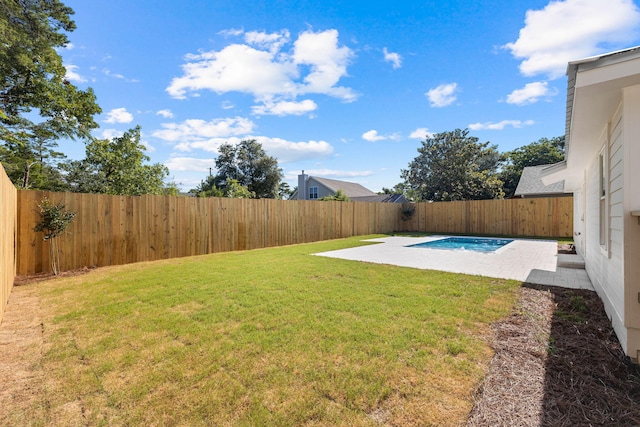 view of yard with a fenced in pool and a patio