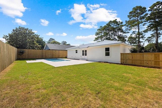 back of house with a patio area, a fenced in pool, and a yard