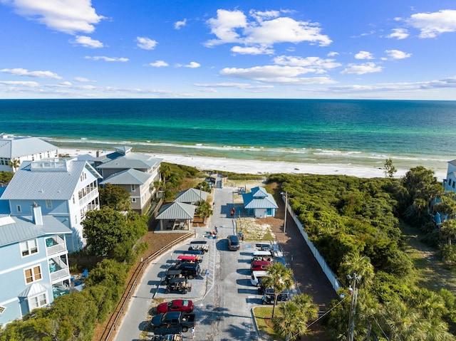 bird's eye view featuring a water view and a view of the beach