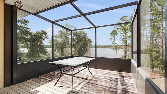 unfurnished sunroom featuring a water view