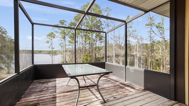 unfurnished sunroom with a water view