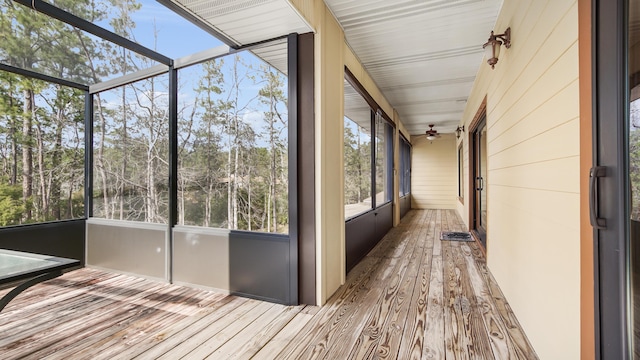 unfurnished sunroom featuring ceiling fan